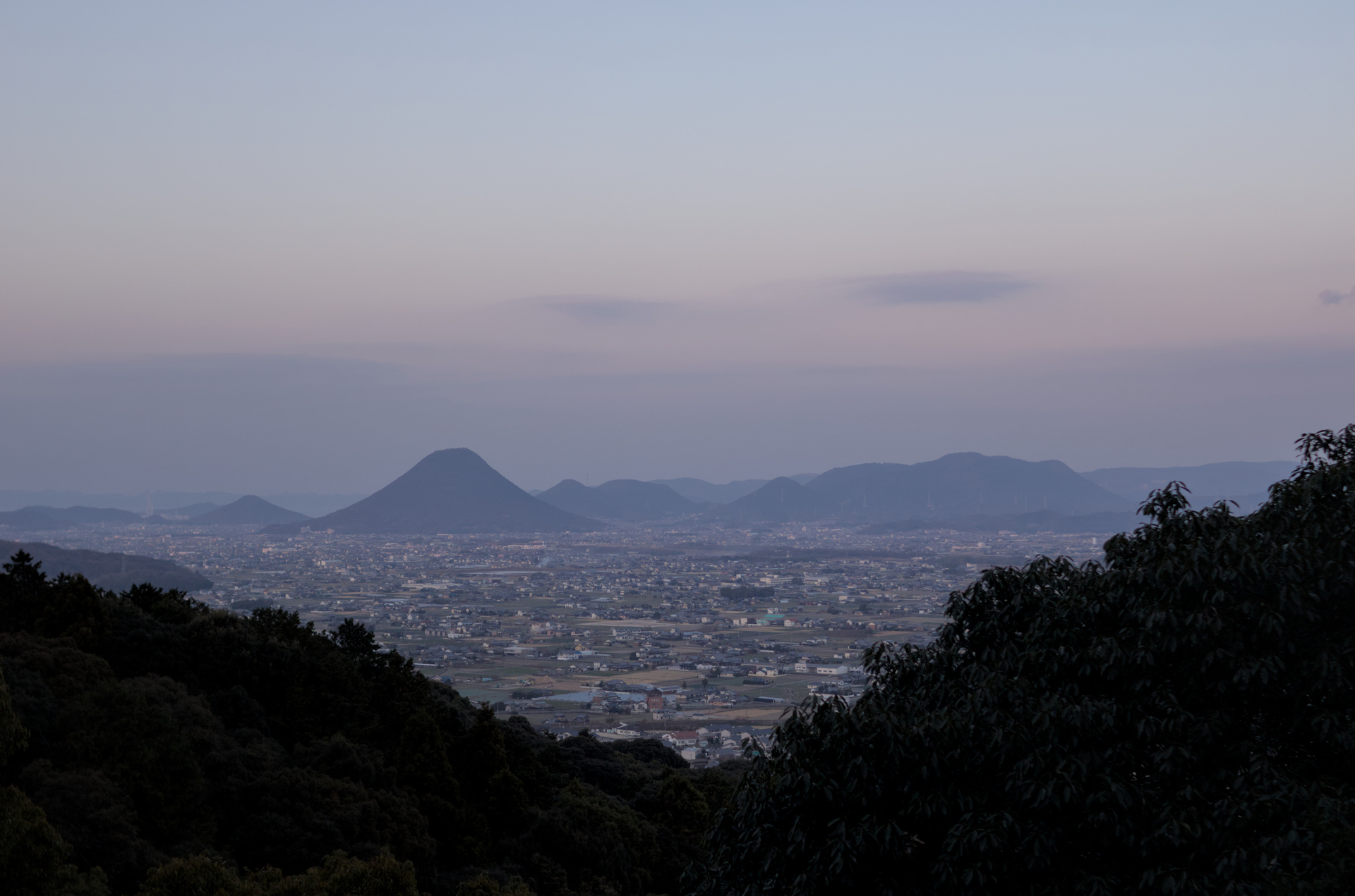City landscape nestled between two hills in the foreground.